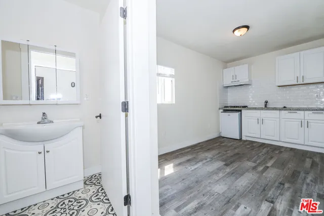 a bathroom with a sink a window and a mirror
