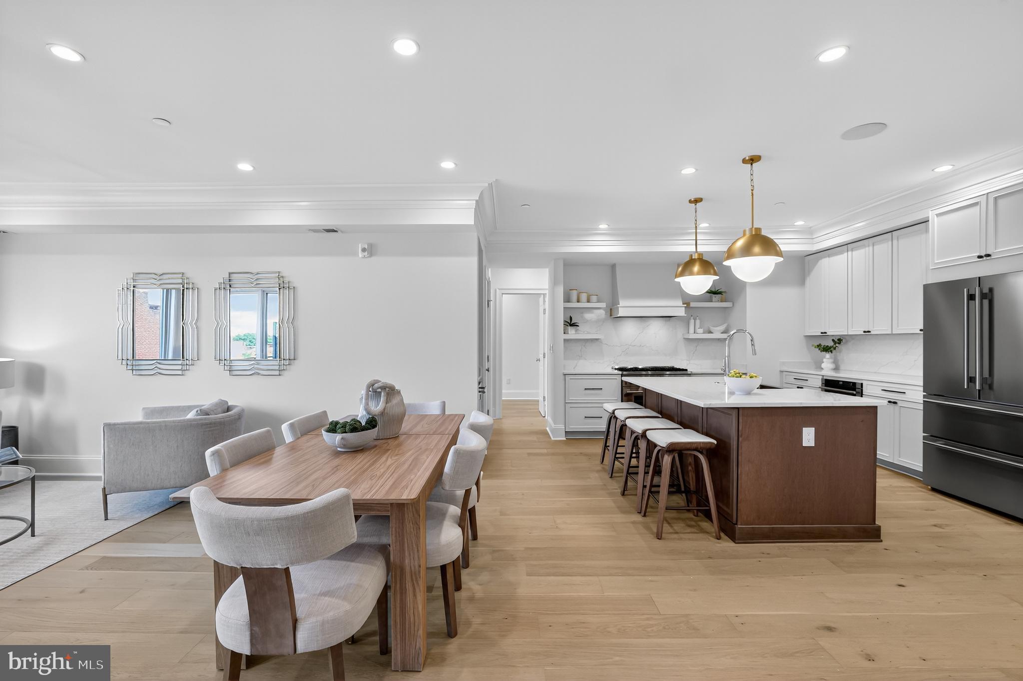 1335 11th Street Northwest, Unit PH2 Washington, DC 20001 - Photo 1 of 25 a kitchen with a dining table chairs stove a sink and a refrigerator