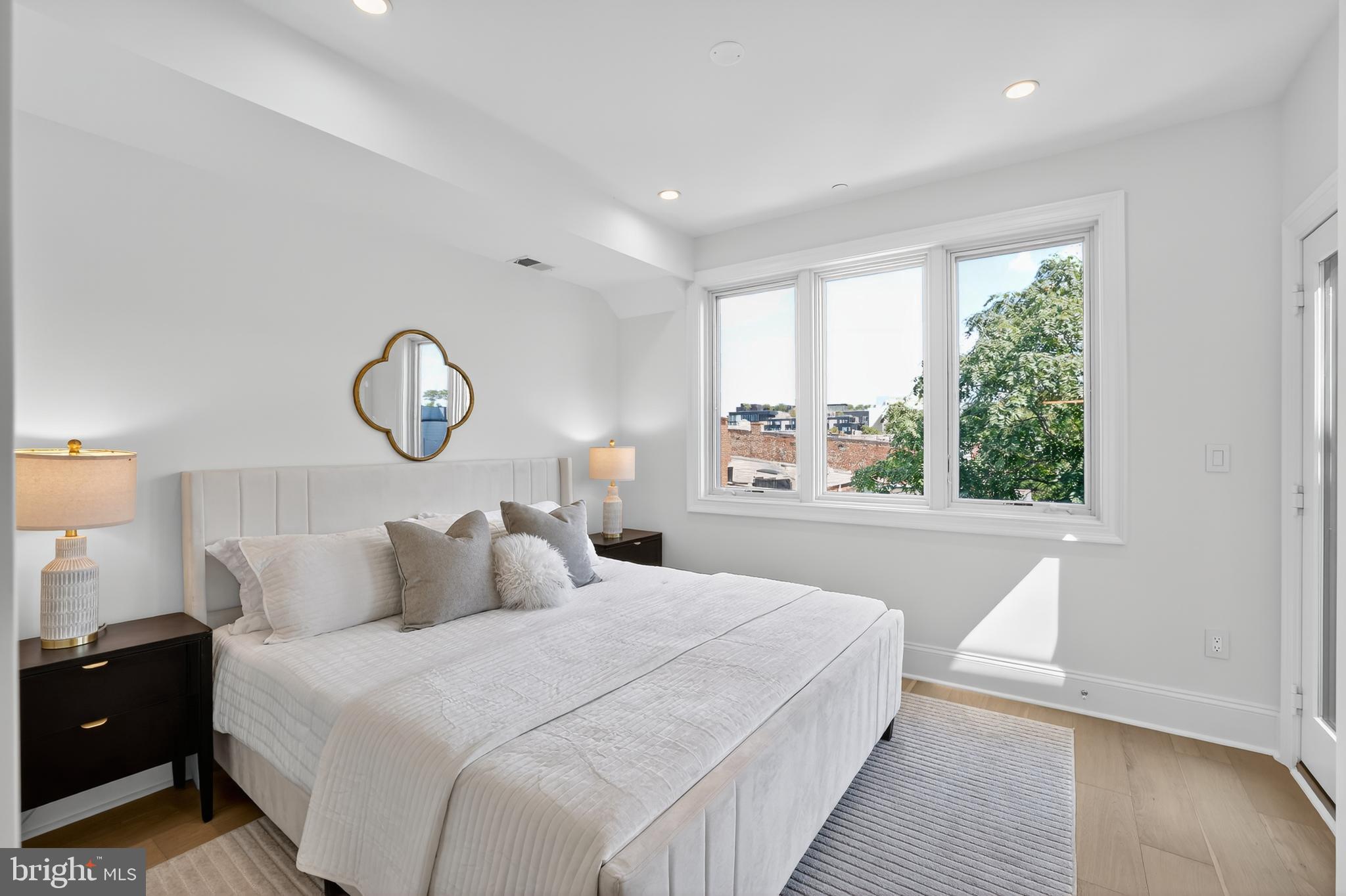 1335 11th Street Northwest, Unit PH2 Washington, DC 20001 - Photo 11 of 25 a bedroom with a large bed and a window