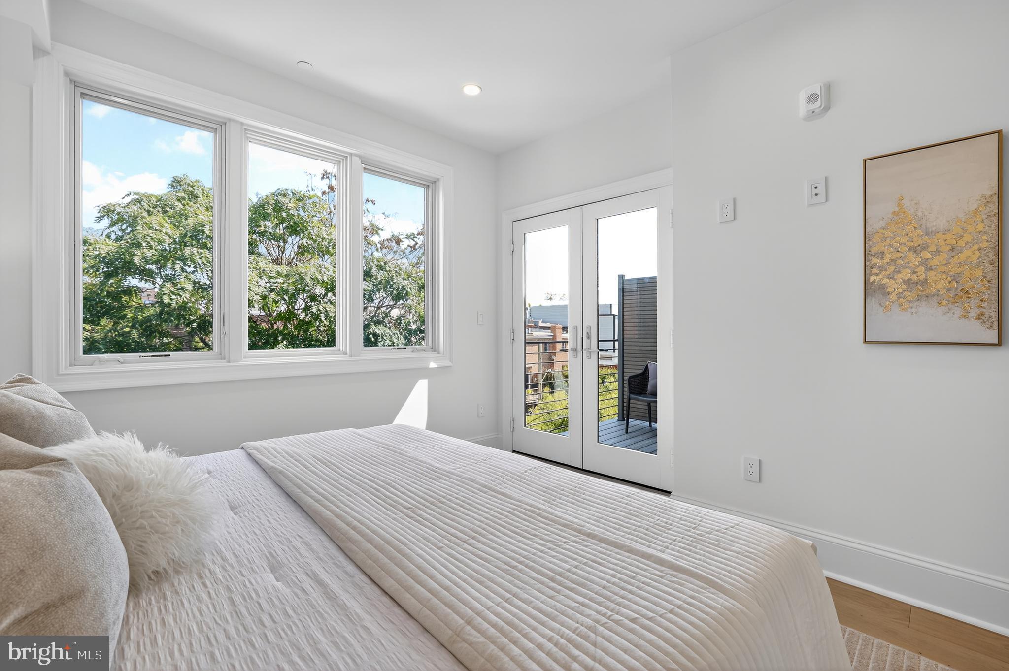 1335 11th Street Northwest, Unit PH2 Washington, DC 20001 - Photo 12 of 25 a bedroom with a large window and a bed