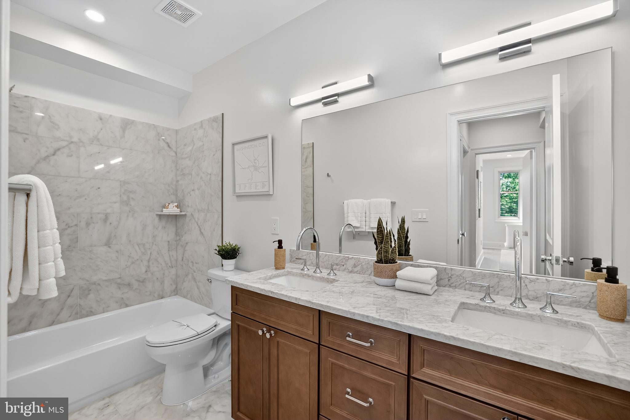 1335 11th Street Northwest, Unit PH2 Washington, DC 20001 - Photo 15 of 25 a bathroom with a granite countertop sink toilet and shower