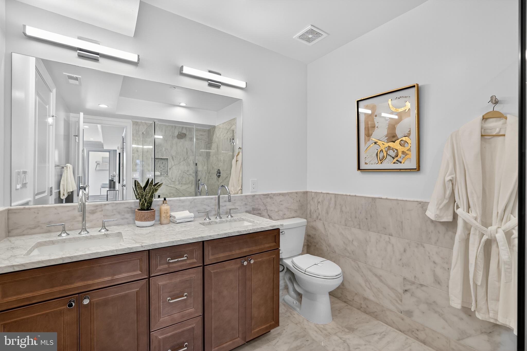 1335 11th Street Northwest, Unit PH2 Washington, DC 20001 - Photo 21 of 25 a bathroom with a toilet sink and mirror