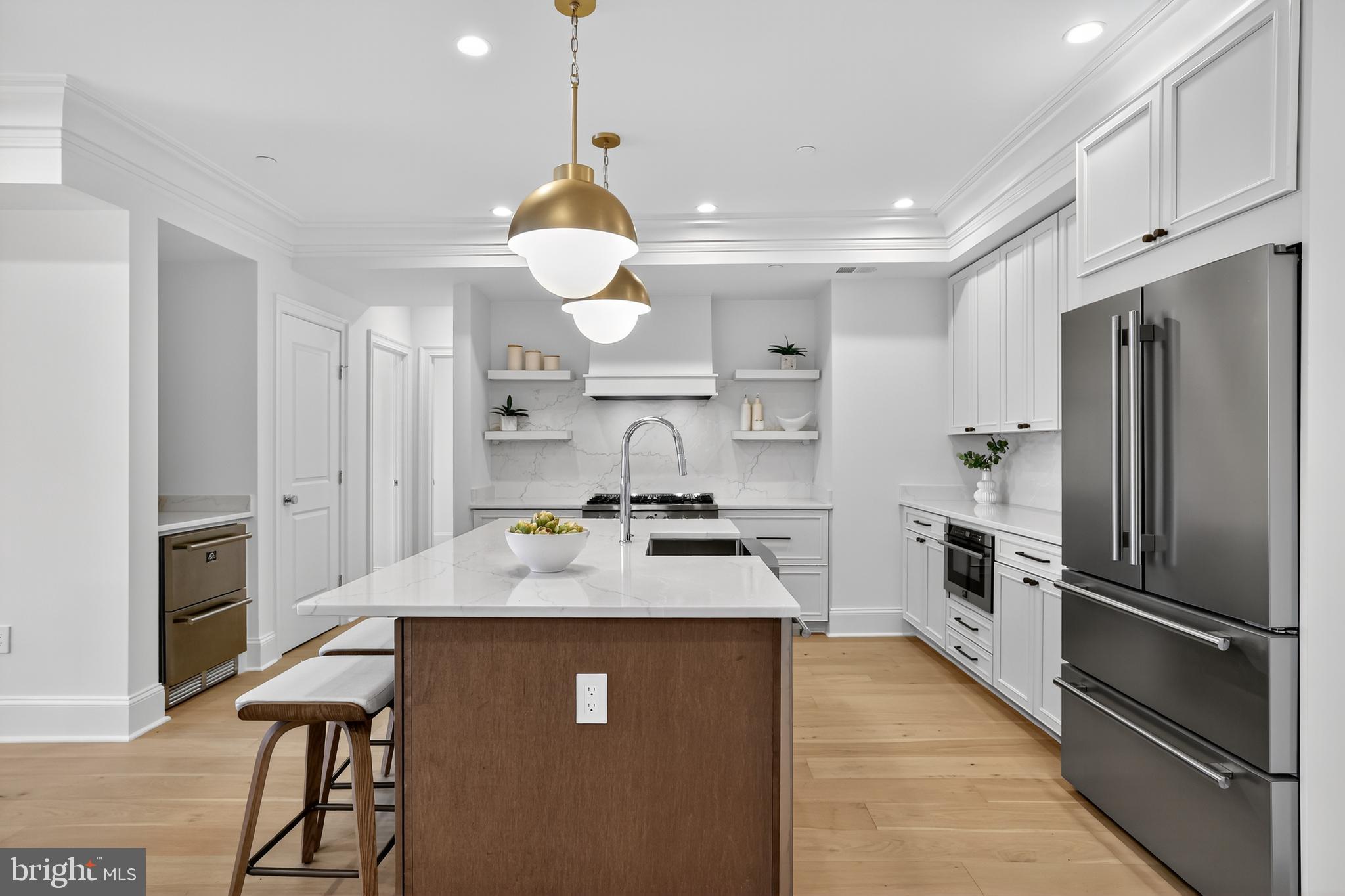 1335 11th Street Northwest, Unit PH2 Washington, DC 20001 - Photo 4 of 25 a kitchen with stainless steel appliances granite countertop a sink refrigerator and cabinets