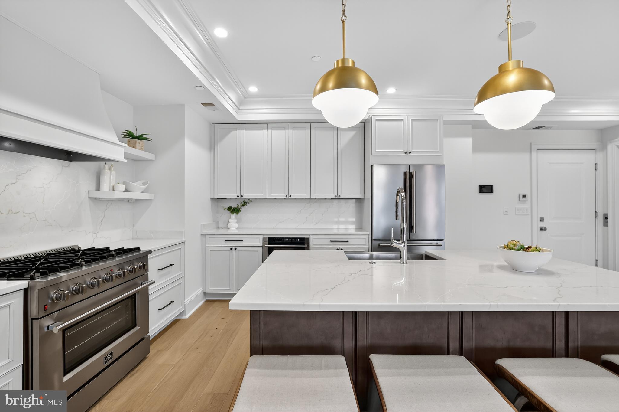 1335 11th Street Northwest, Unit PH2 Washington, DC 20001 - Photo 5 of 25 a kitchen with a sink a stove and chairs