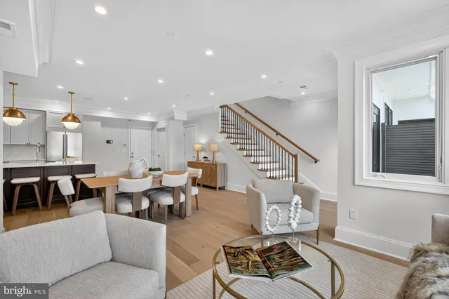 a living room with furniture wooden floor and a window