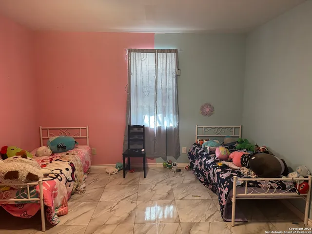 a view of an empty room with windows and closet