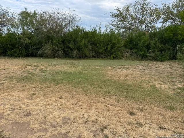 a view of a lake with houses in the back
