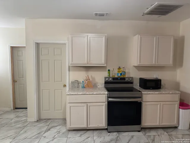 a bedroom with a bed window and couch