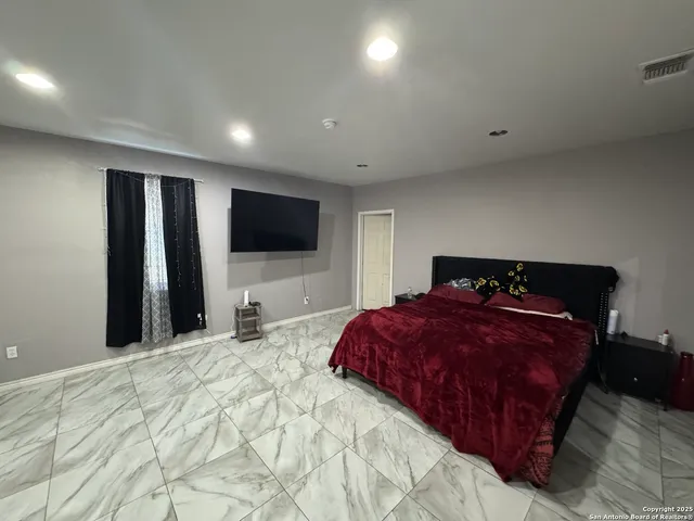 a bedroom with a bed and a bathroom