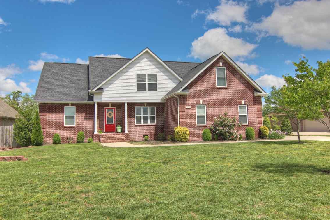 a front view of house with yard and green space