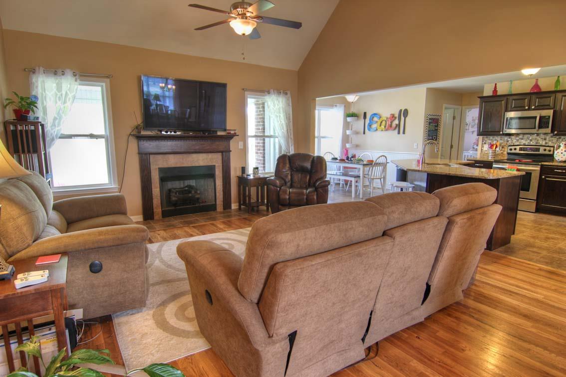 3928 Rowland Road Murfreesboro, TN 37128 - Photo 4 of 25 a living room with furniture a fireplace and a flat screen tv