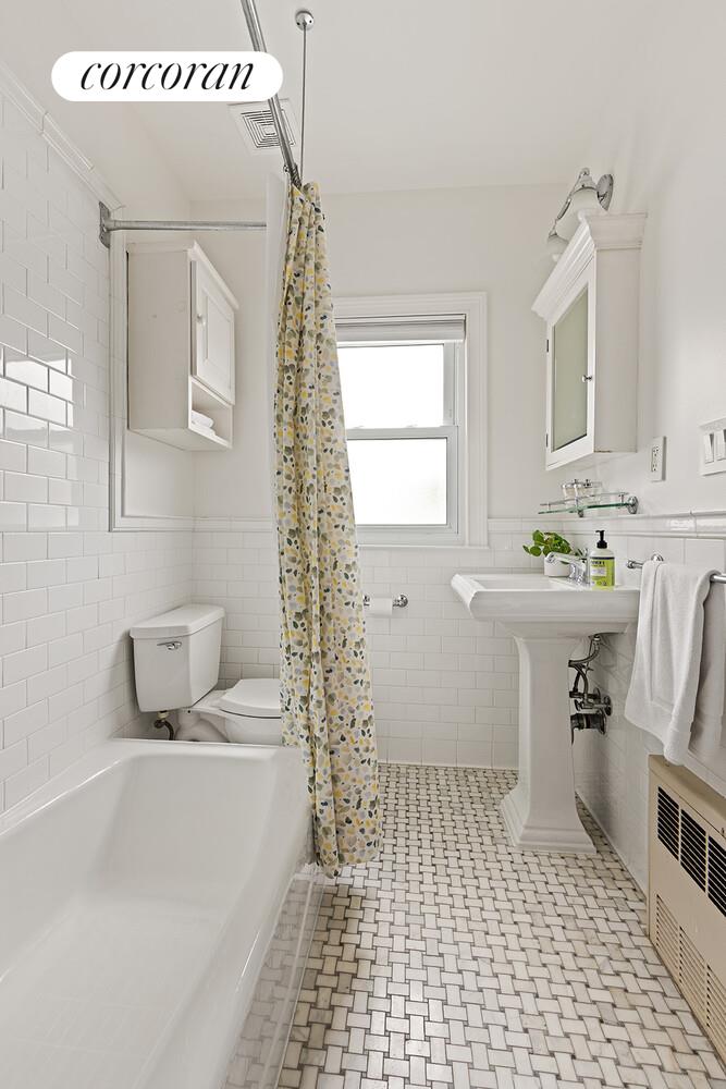 7709 Colonial Road Brooklyn, NY 11209 - Photo 11 of 13 a bathroom with a sink a toilet and a bathtub