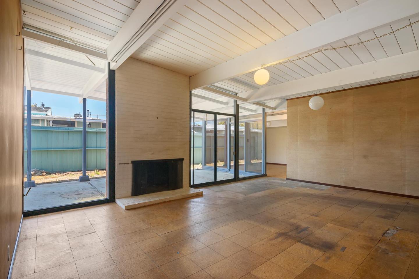 1705 Wolfe Drive San Mateo, CA 94402 - Photo 3 of 22 a view of an empty room with a fireplace and a window