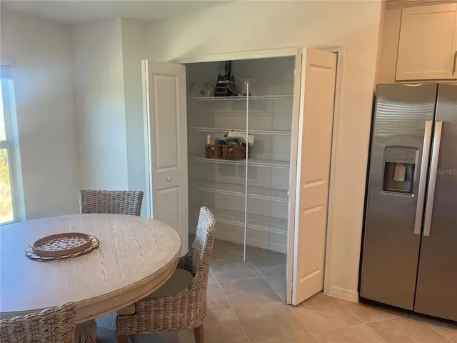a kitchen that has a table and chairs in it