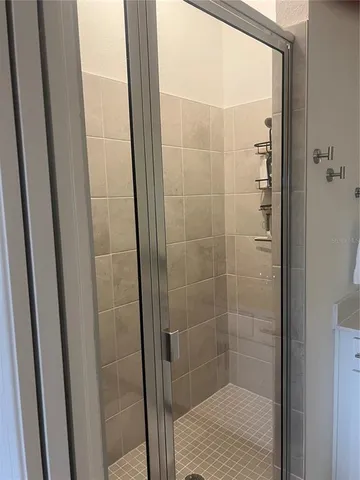 a bathroom with a glass door shower