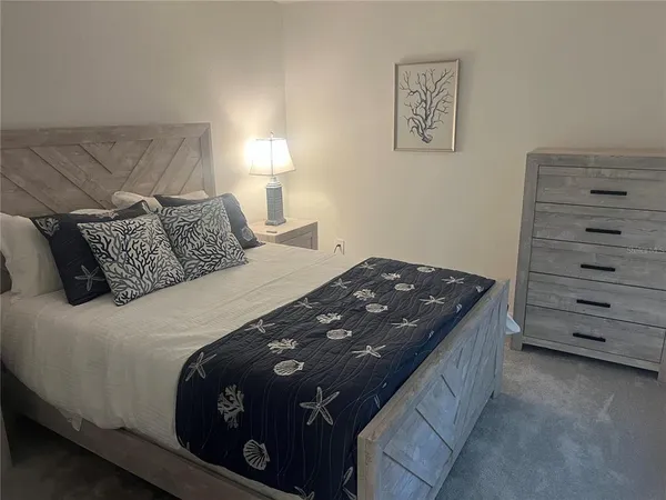 a bedroom with a bed and a night stand