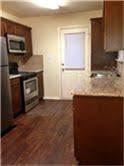 806 Parkplace Ridge Princeton, TX 75407 - Photo 4 of 14 a kitchen with granite countertop white cabinets and stainless steel appliances