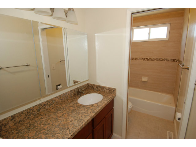 25 Point Reyes Way Pacifica, CA 94044 - Photo 17 of 22 a bathroom with a sink vanity granite tub and a mirror