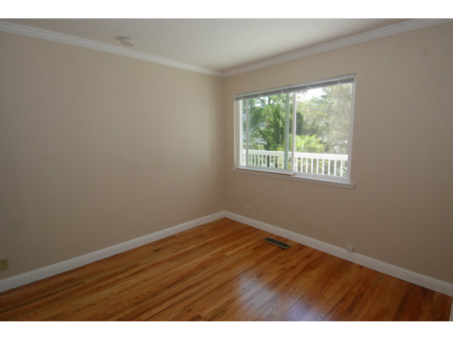25 Point Reyes Way Pacifica, CA 94044 - Photo 18 of 22 an empty room with wooden floor and windows
