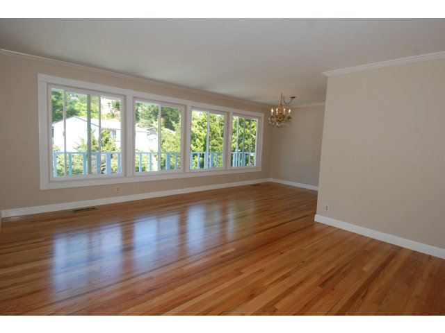25 Point Reyes Way Pacifica, CA 94044 - Photo 3 of 22 a view of an empty room with wooden floor and a window