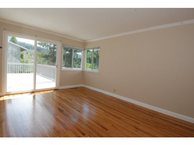 25 Point Reyes Way Pacifica, CA 94044 - Photo 6 of 22 a view of an empty room with wooden floor and a window