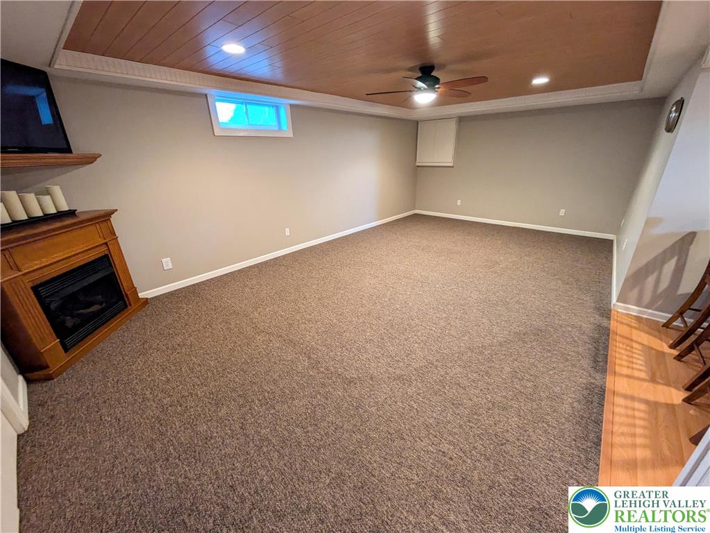 3285 Cherryville Road Northampton, PA 18067 - Photo 37 of 51 Warm wood ceiling panels and a classic fireplace frame this comfortable lower level living area.