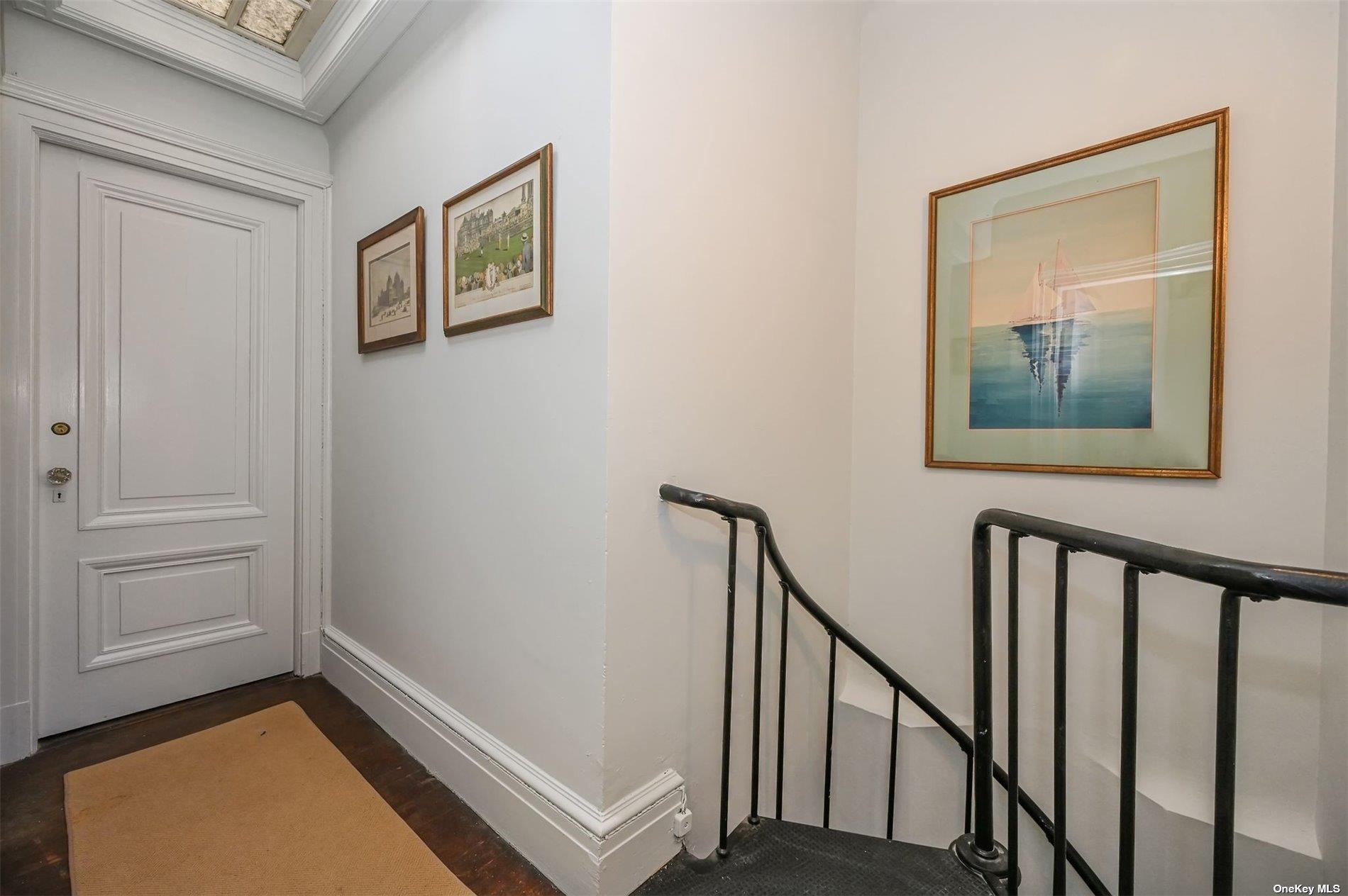 - Wheatley Road Old Westbury, NY 11568 - Photo 29 of 36 Back guest hall with spiral staircase