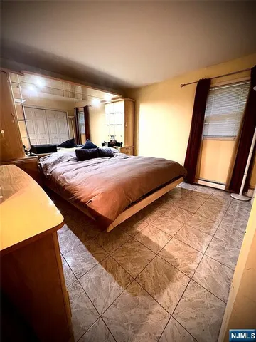 a bedroom with bed and window