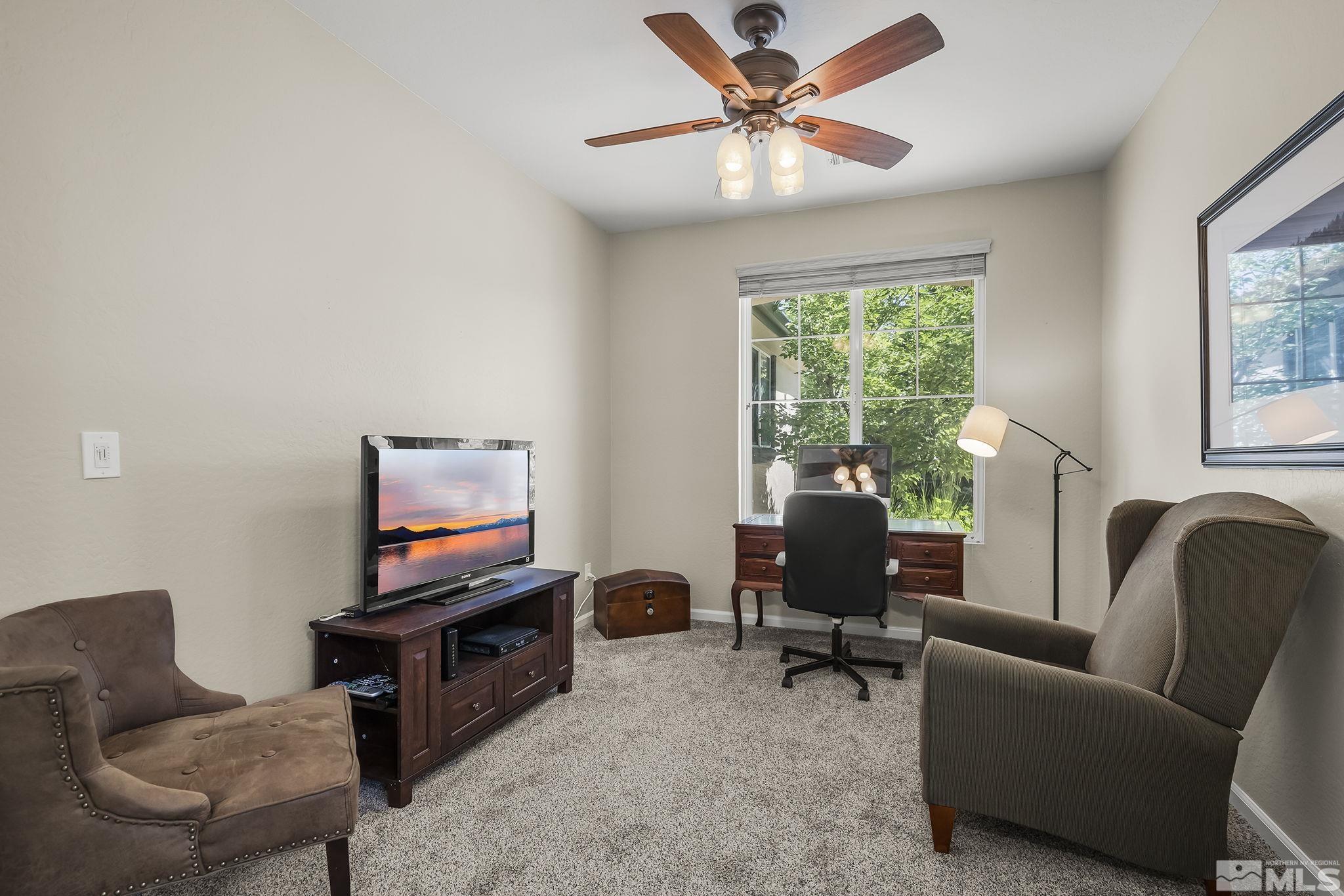 1375 Tarleton Way Reno, NV 89523 - Photo 13 of 22 a living room with furniture a fireplace and a flat screen tv