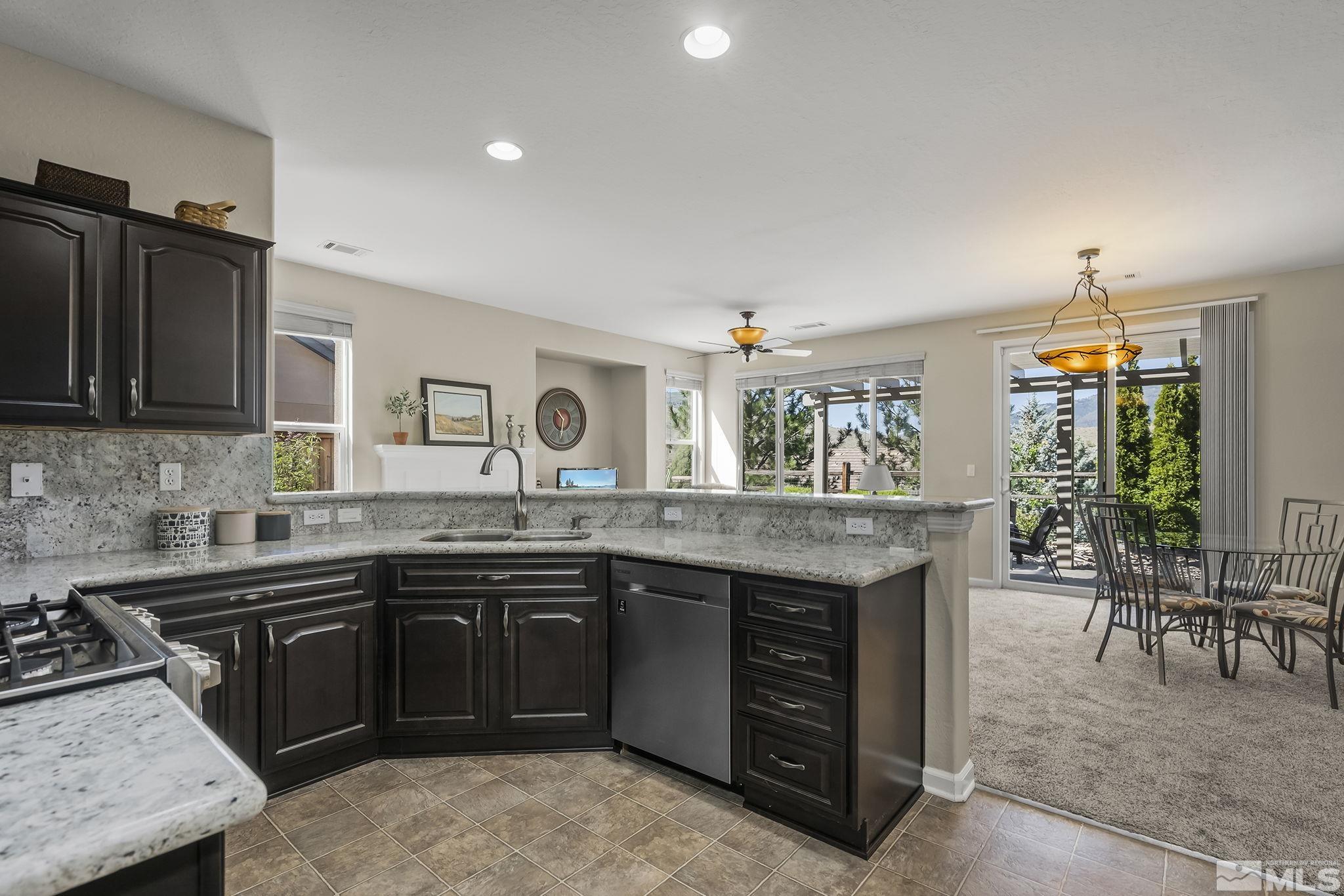 1375 Tarleton Way Reno, NV 89523 - Photo 16 of 22 a kitchen with granite countertop a sink stove and refrigerator
