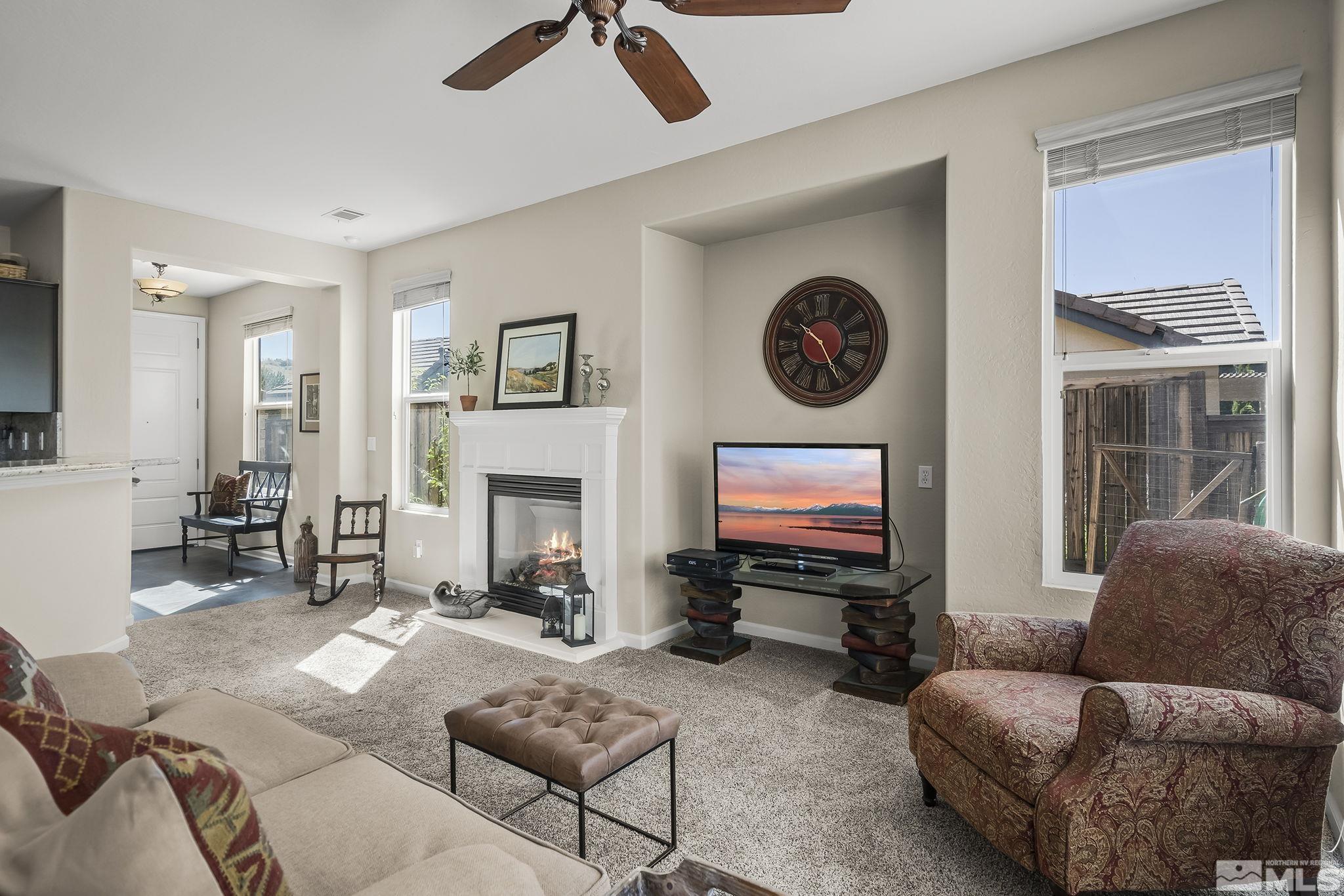 1375 Tarleton Way Reno, NV 89523 - Photo 5 of 22 a living room with furniture a fireplace and a flat screen tv