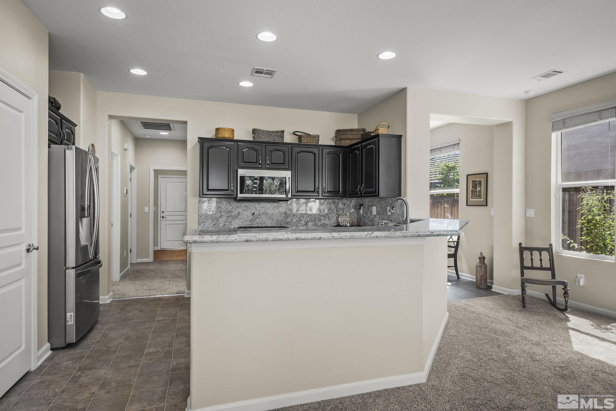 1375 Tarleton Way Reno, NV 89523 - Photo 7 of 22 a kitchen with stainless steel appliances granite countertop a refrigerator and a sink
