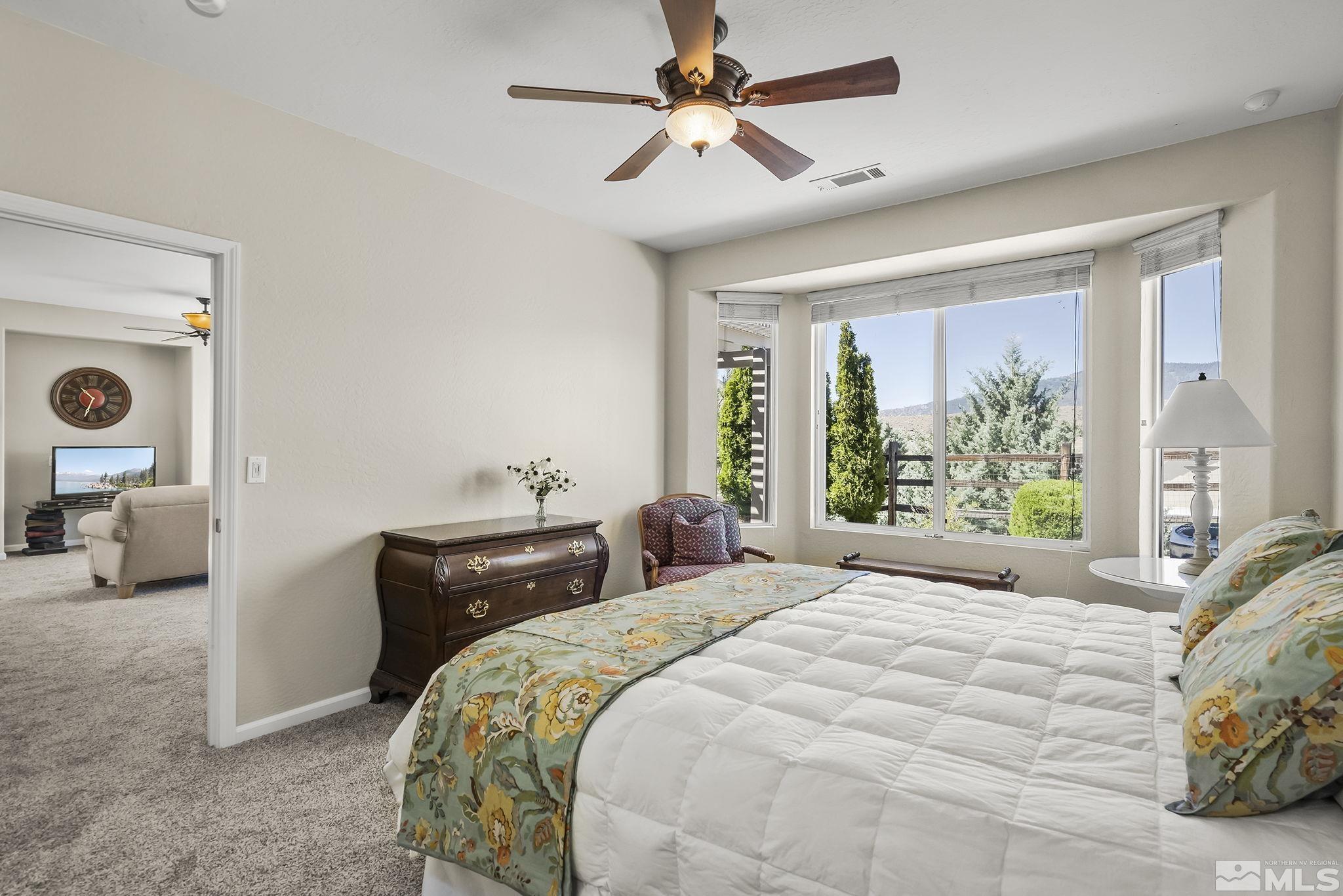 1375 Tarleton Way Reno, NV 89523 - Photo 10 of 22 a bedroom with a bed and a chandelier