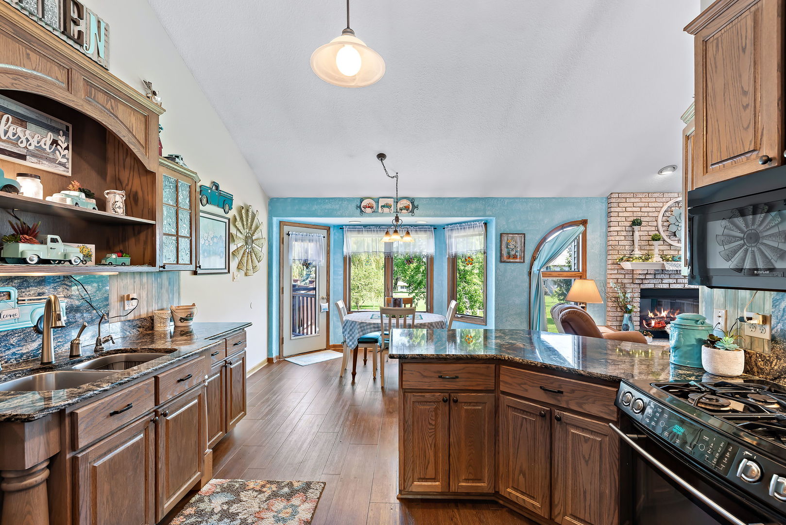 2364 Sunset View Lane Kankakee, IL 60901 - Photo 14 of 35 a kitchen with stainless steel appliances a stove a sink dishwasher and cabinets with wooden floor