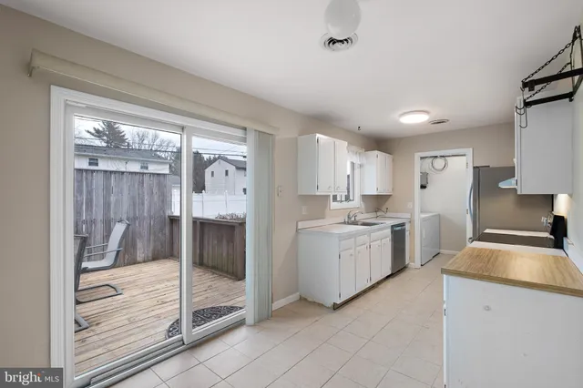 a kitchen with a refrigerator a sink and a stove top oven