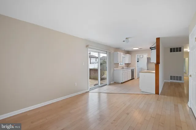 a view of a kitchen with a sink and a refrigerator