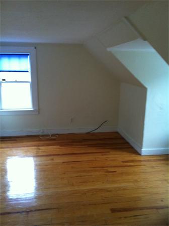 34 Wilkins Road Braintree, MA 02184 - Photo 9 of 12 a view of empty room with window and wooden floor