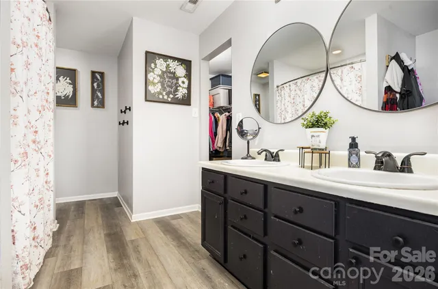 a bathroom with a double vanity sink and a mirror