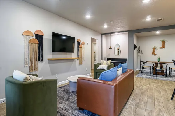 a living room with furniture and a flat screen tv