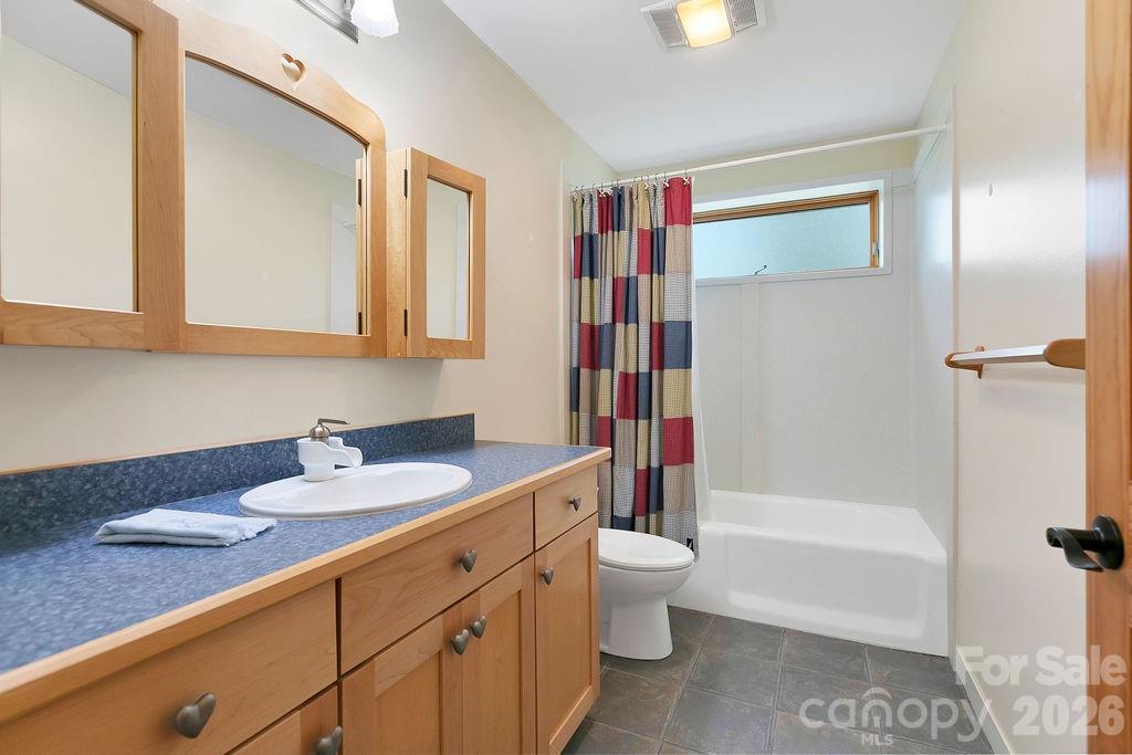 40 Walnut Ridge Road Brevard, NC 28712 - Photo 36 of 47 a bathroom with a granite countertop sink toilet and shower