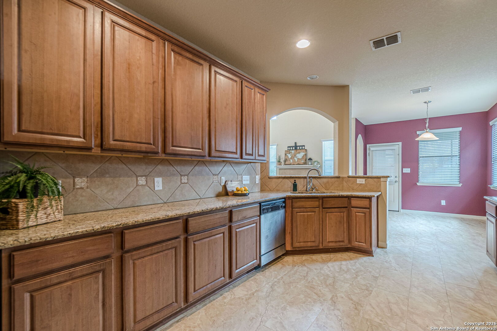 204 Wildcat Run Cibolo, TX 78108 - Photo 11 of 41 a kitchen with stainless steel appliances granite countertop a sink a stove and a wooden cabinets