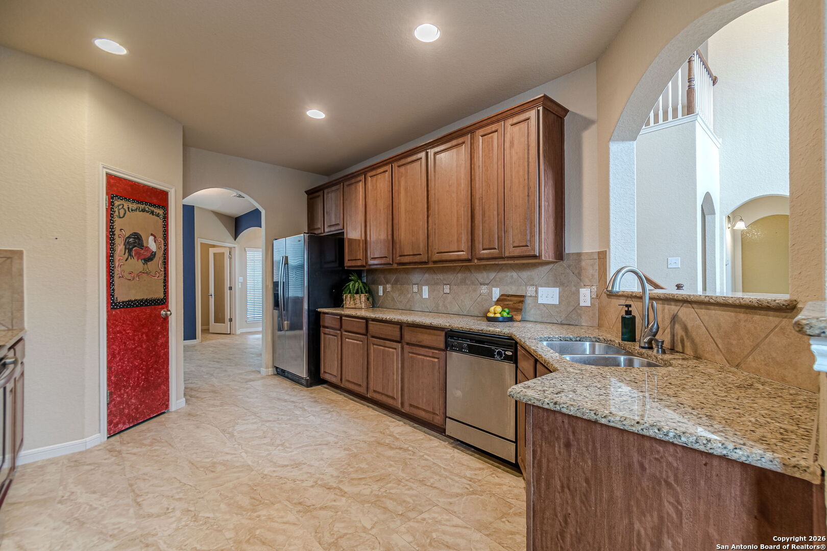 204 Wildcat Run Cibolo, TX 78108 - Photo 12 of 41 a kitchen with granite countertop a sink stove and cabinets