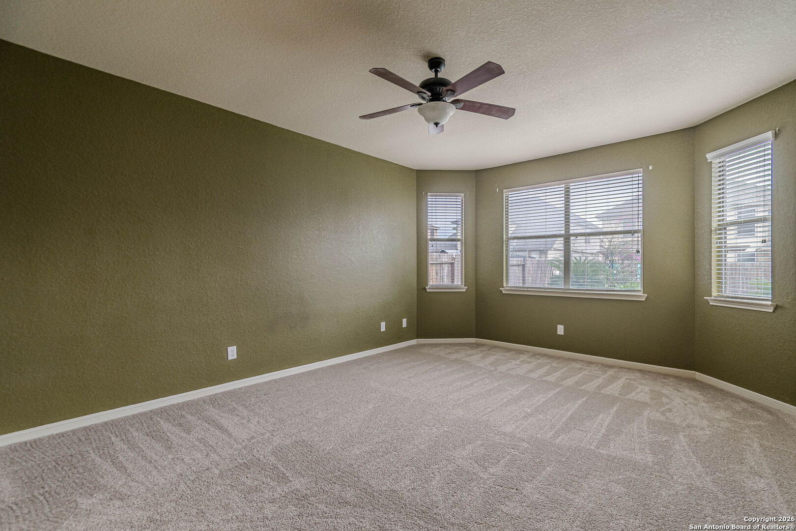 204 Wildcat Run Cibolo, TX 78108 - Photo 20 of 41 a view of a big room with windows and chandelier fan