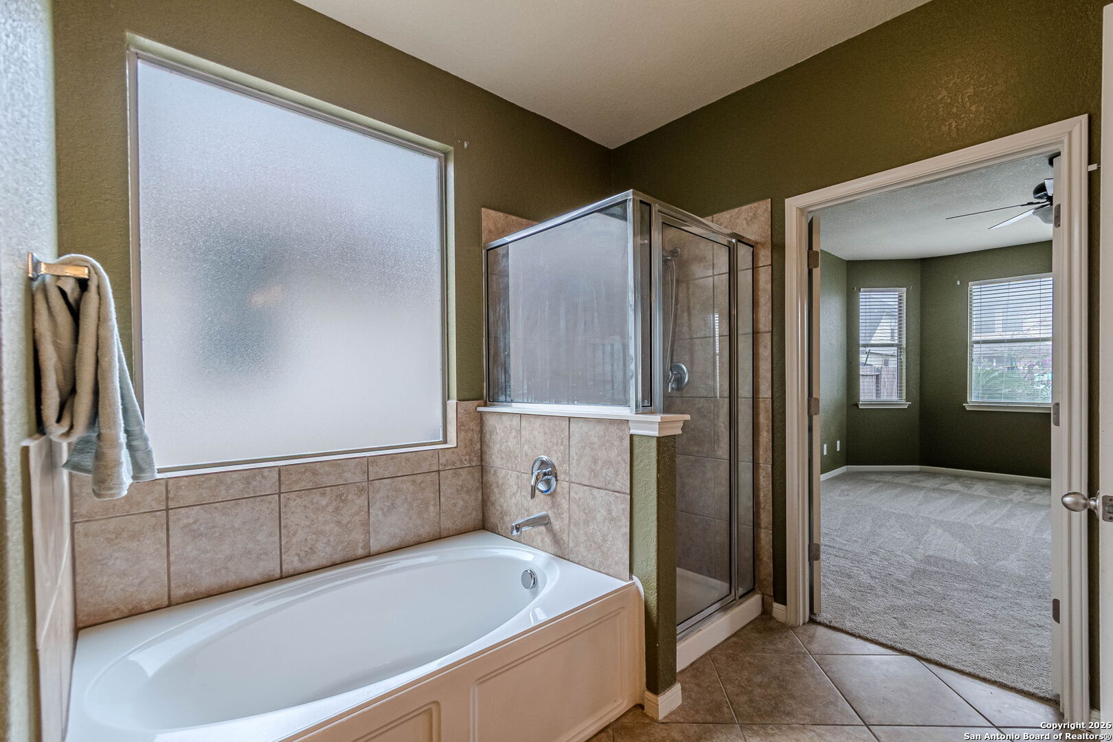 204 Wildcat Run Cibolo, TX 78108 - Photo 25 of 41 a bathroom with a bathtub and a shower