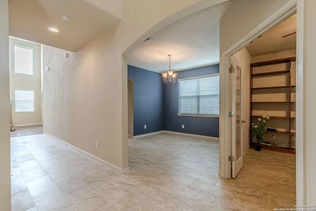 an empty room with closet and a bathroom