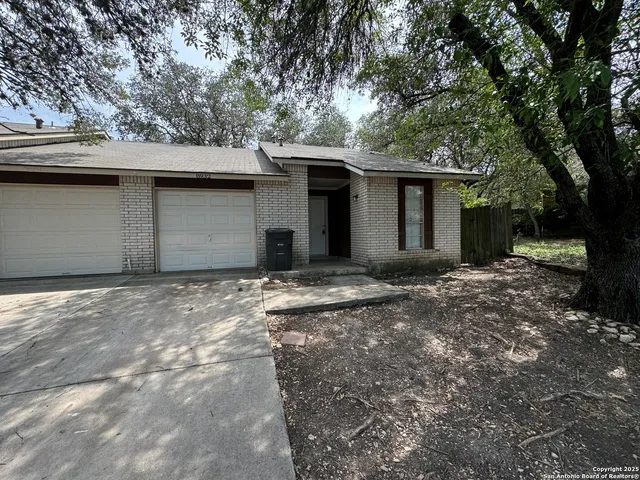 a view of a house with a yard and garage