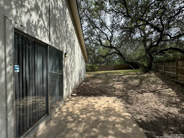 a yellow house with trees in front of it