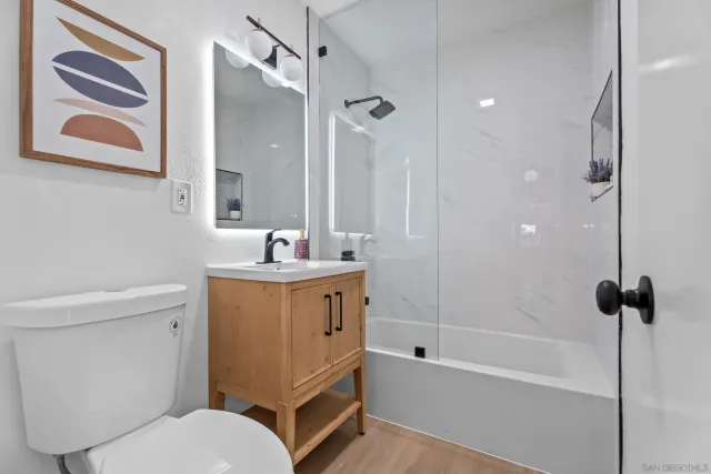 a bathroom with a sink toilet and shower