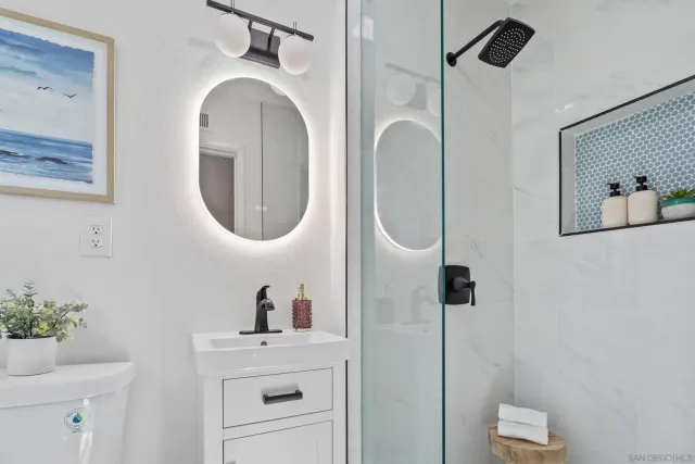 a bathroom with a sink mirror and vanity