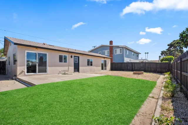 a front view of house with a garden and patio